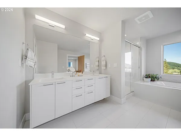 a spacious bathroom with a granite countertop sink mirror and a bathtub