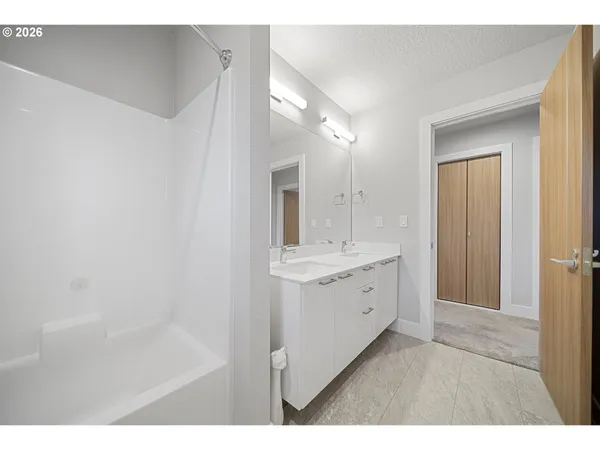 a bathroom with a sink a mirror and a bathtub
