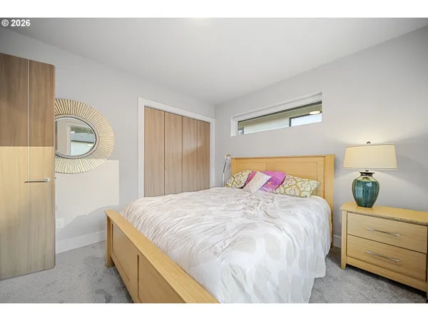 a bedroom with a bed and a dresser