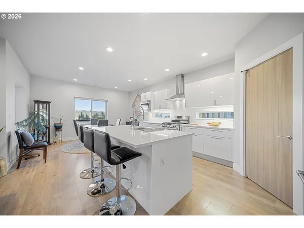 a kitchen with a dining table chairs refrigerator and cabinets