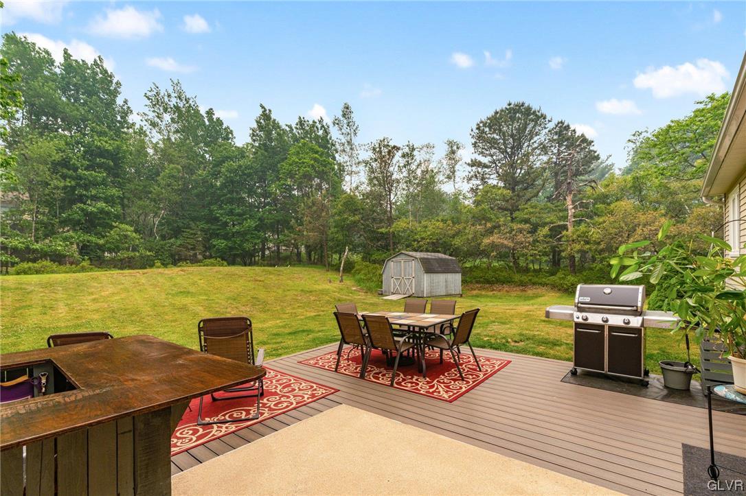 205 Ryan Road Blakeslee, PA 18610 - Photo 28 of 34 a roof deck with table and chairs a barbeque with wooden floor and fence