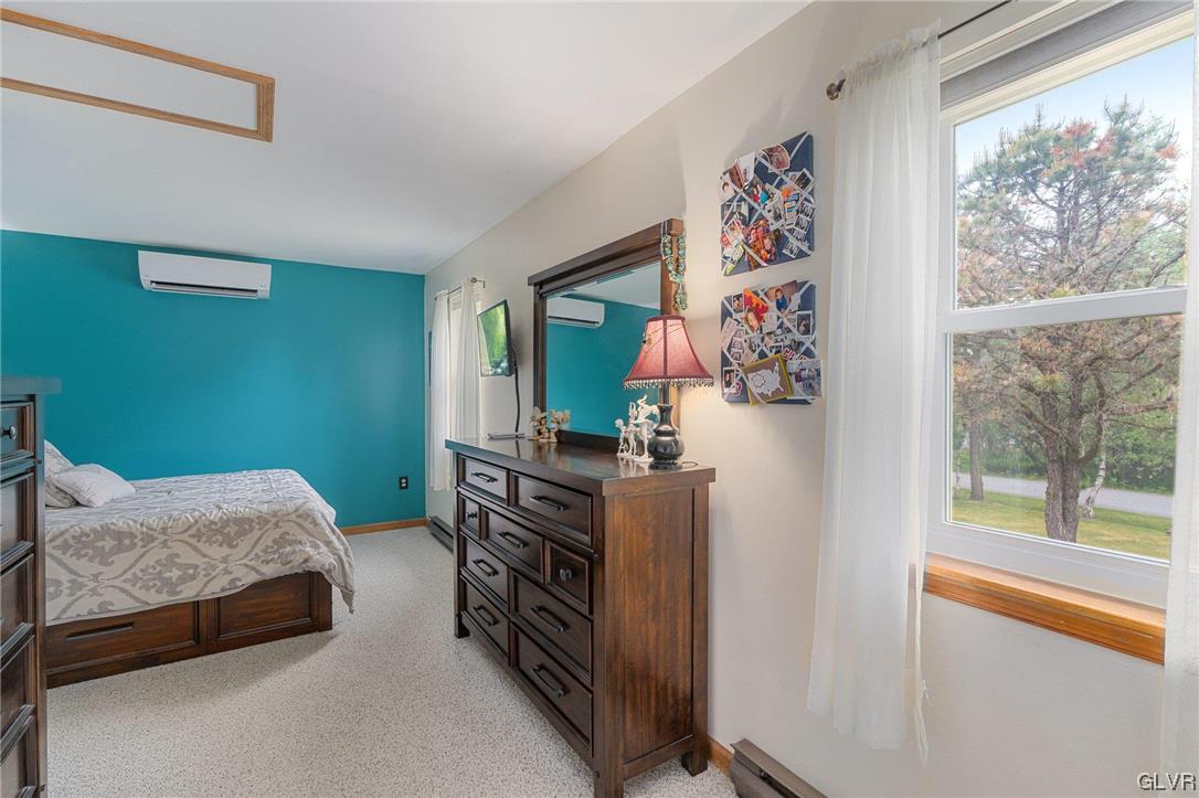 205 Ryan Road Blakeslee, PA 18610 - Photo 8 of 34 a bedroom with a bed and a painting on the wall