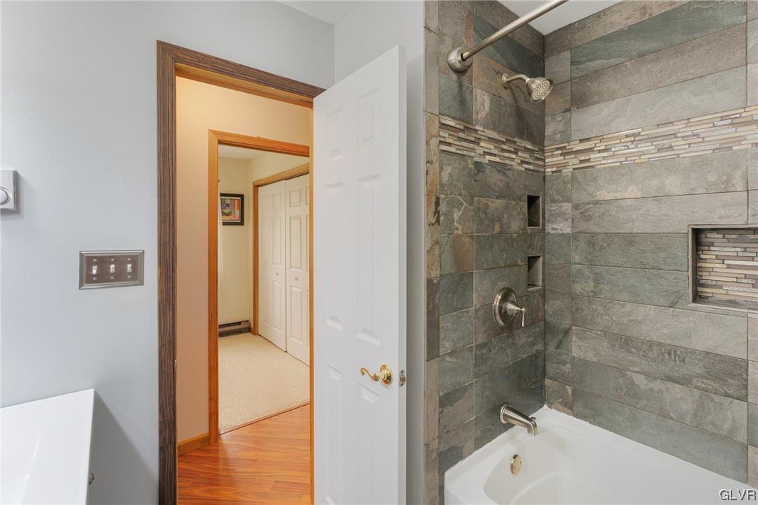 205 Ryan Road Blakeslee, PA 18610 - Photo 10 of 34 a bathroom with a shower and a bath tub