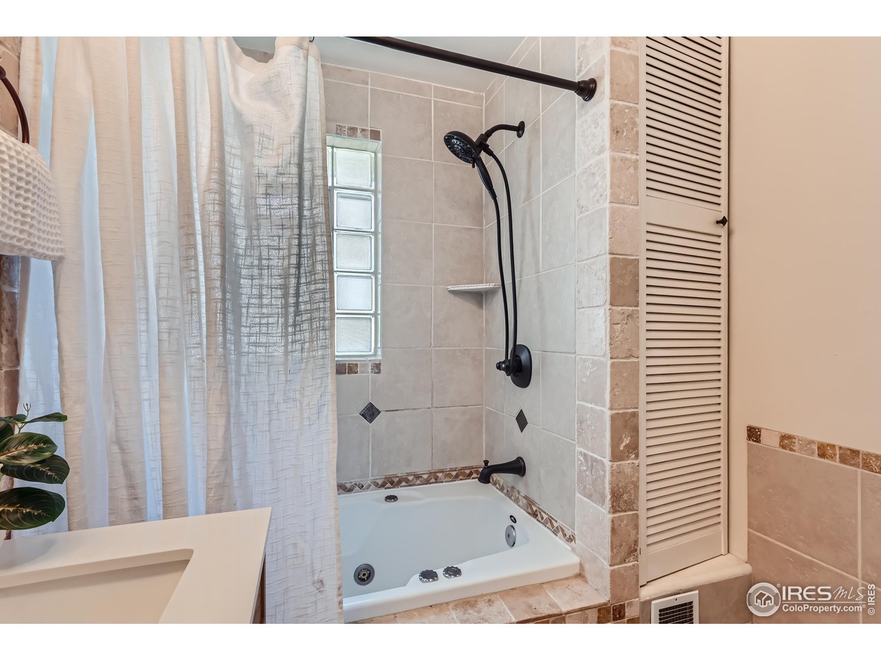 25 Reed Place Longmont, CO 80504 - Photo 13 of 30 a bathroom with a bath tub and a shower curtain