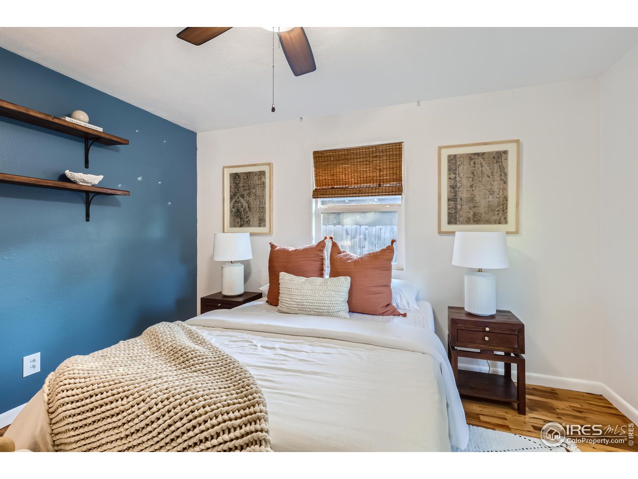 25 Reed Place Longmont, CO 80504 - Photo 10 of 30 a bedroom with a bed and a lamp on table