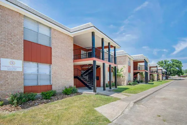 a view of a building with a yard