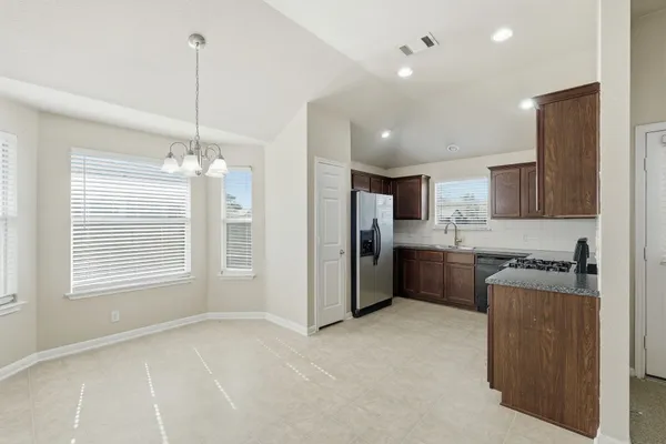 a kitchen with refrigerator cabinets and counter top