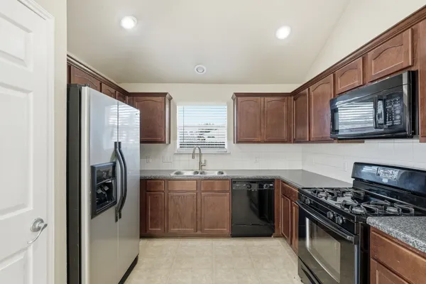 a kitchen with a sink stove and refrigerator
