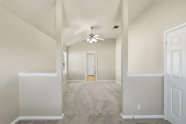 a view of a chandelier fan and entryway