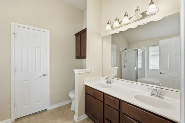 a bathroom with a double vanity sink and a mirror