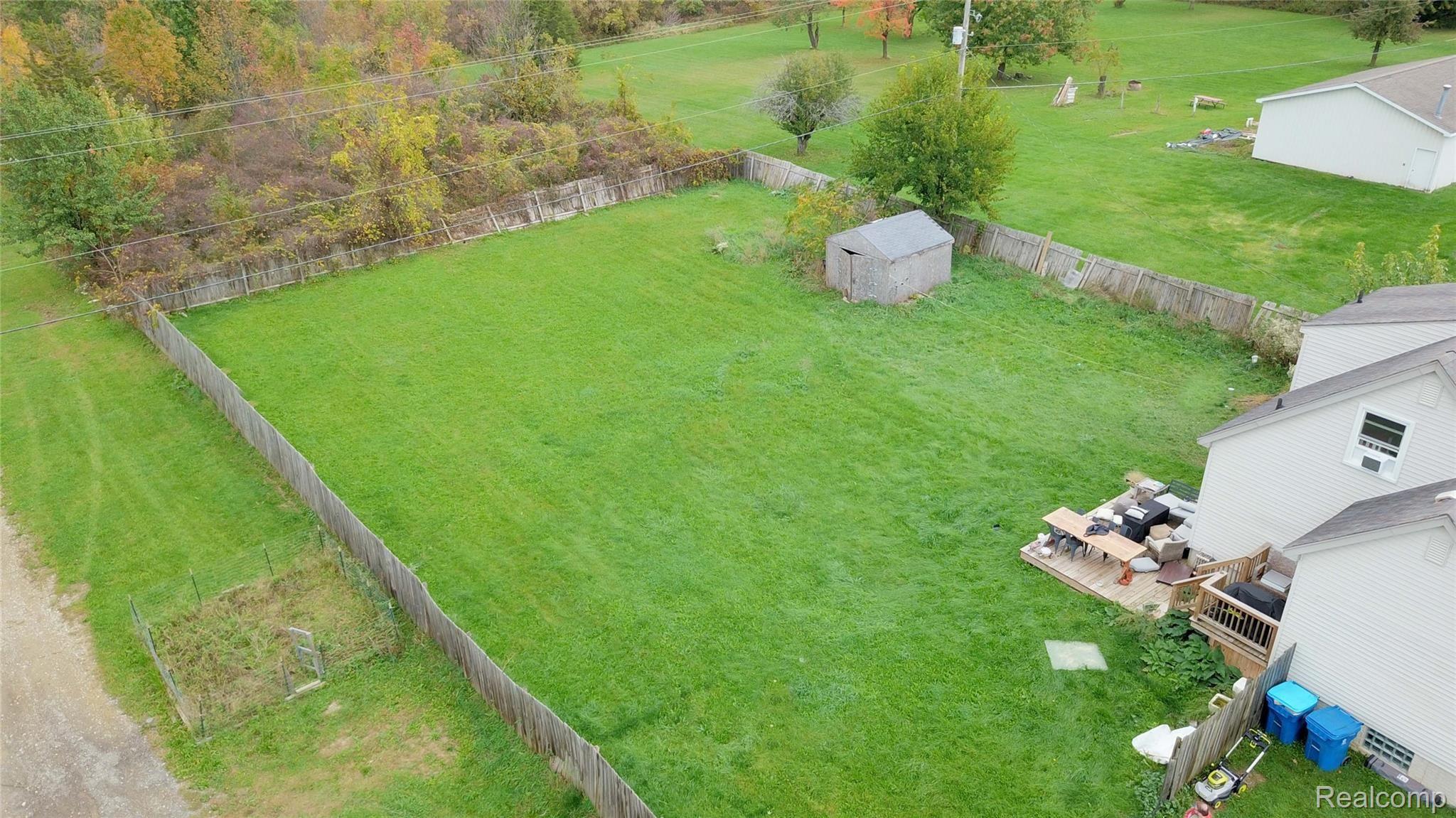 4374 Lahring Road Linden, MI 48451 - Photo 15 of 17 Fenced Backyard with Shed