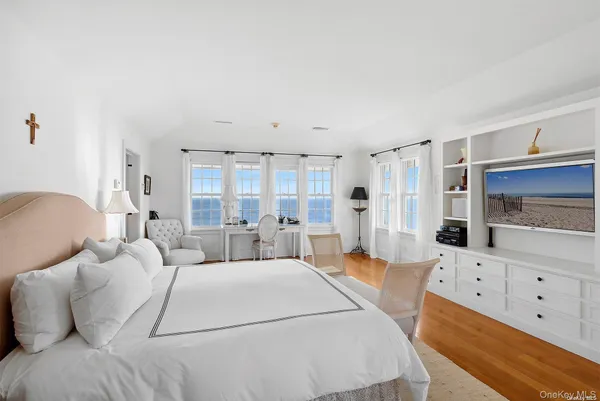 a large white bed in a white room