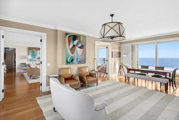 a living room with furniture a dining table and a window