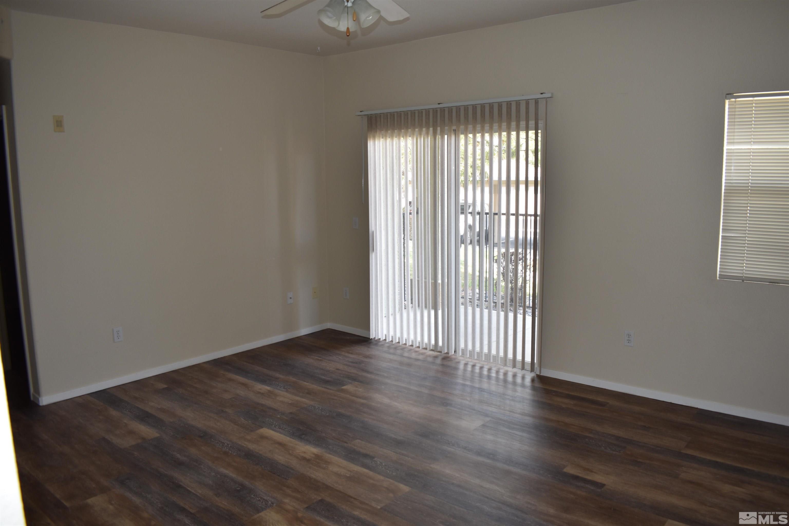 6850 Sharlands Avenue, Unit W1133 Reno, NV 89523 - Photo 4 of 17 an empty room with wooden floor and windows