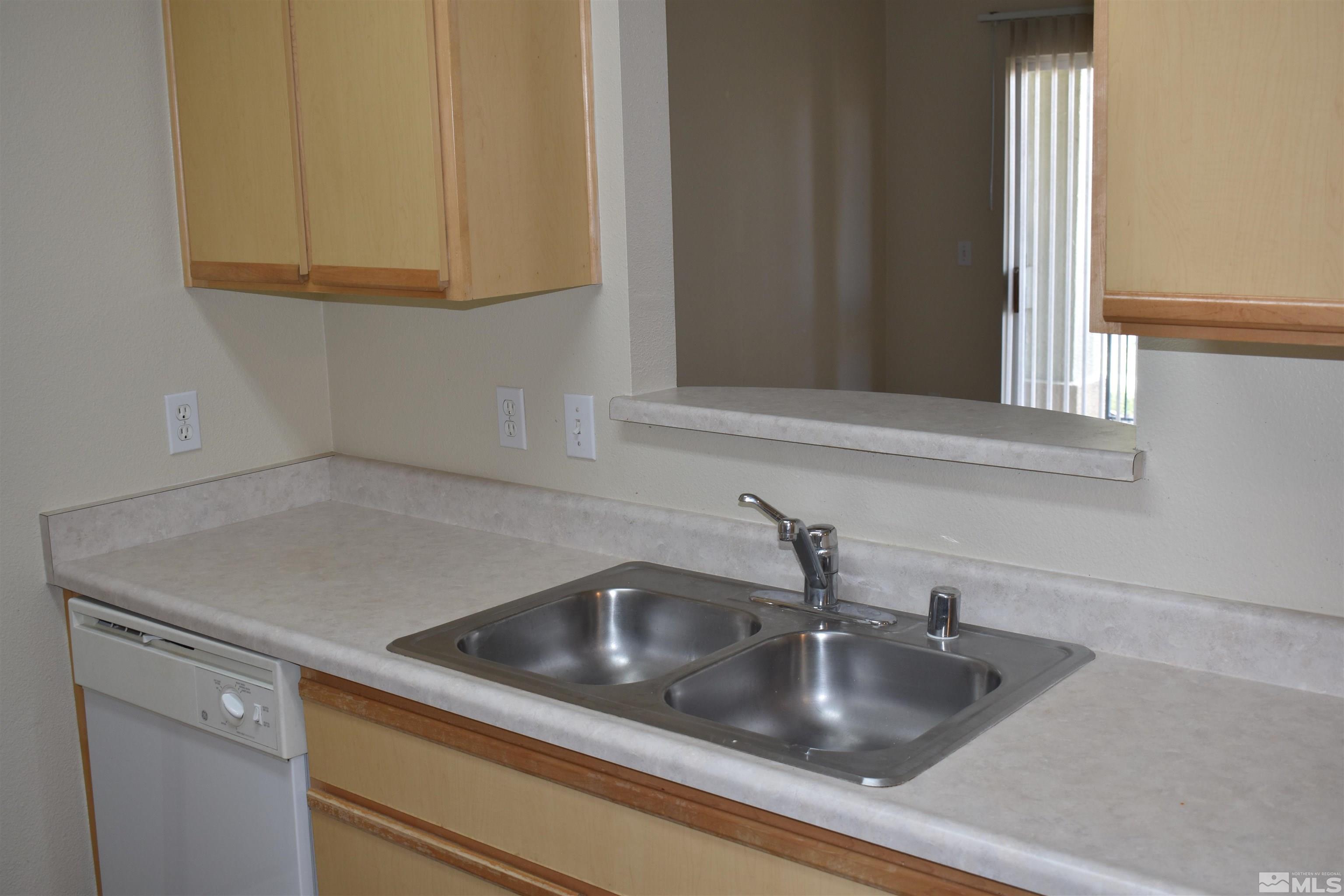 6850 Sharlands Avenue, Unit W1133 Reno, NV 89523 - Photo 7 of 17 a kitchen with sink and cabinets