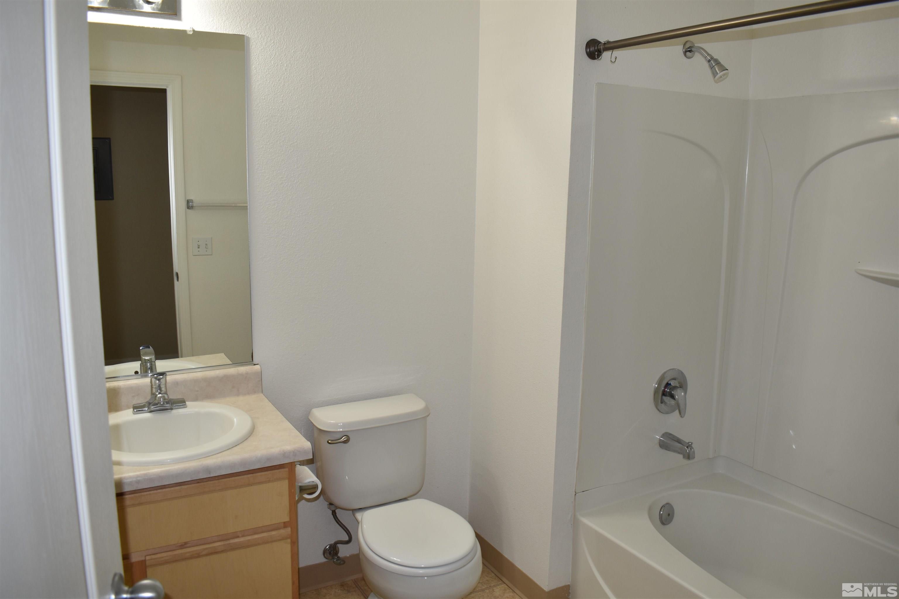 6850 Sharlands Avenue, Unit W1133 Reno, NV 89523 - Photo 9 of 17 a bathroom with a sink toilet and shower