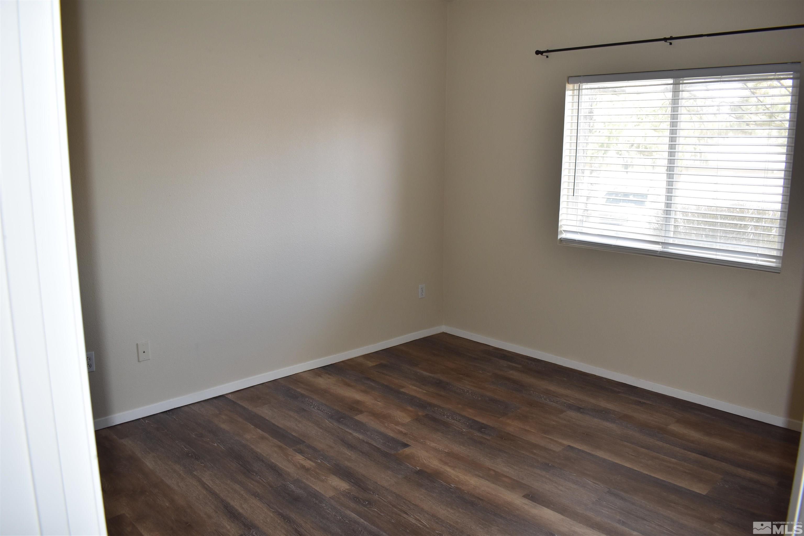 6850 Sharlands Avenue, Unit W1133 Reno, NV 89523 - Photo 10 of 17 wooden floor in an empty room with a window