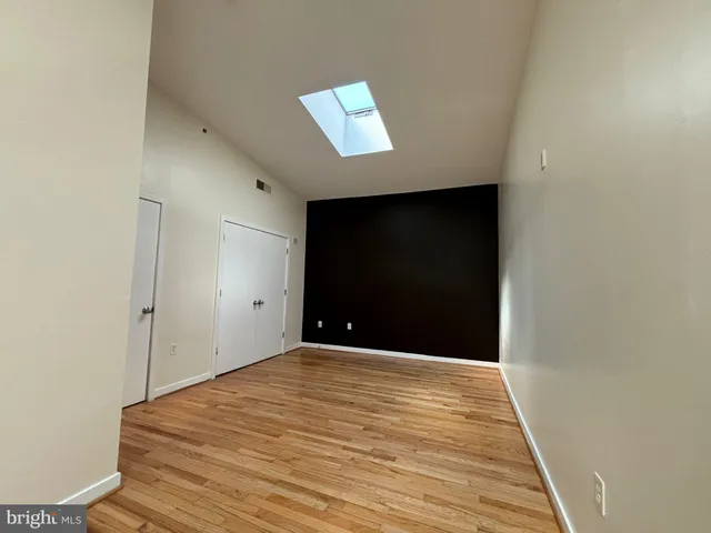 a view of walk in closet with empty racks