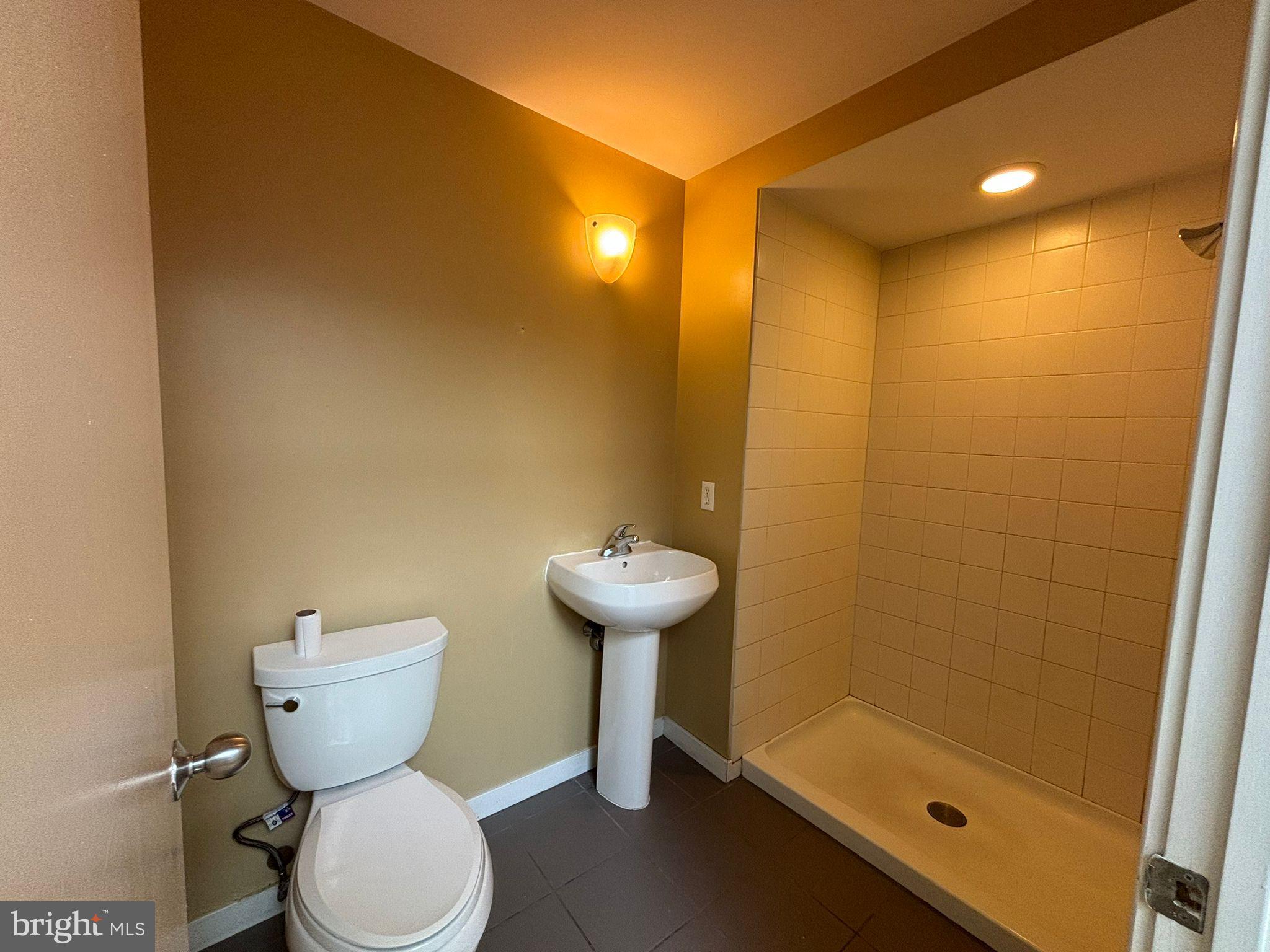 242 Centre Street, Unit 12 Trenton, NJ 08611 - Photo 21 of 23 a bathroom with a sink and a toilet