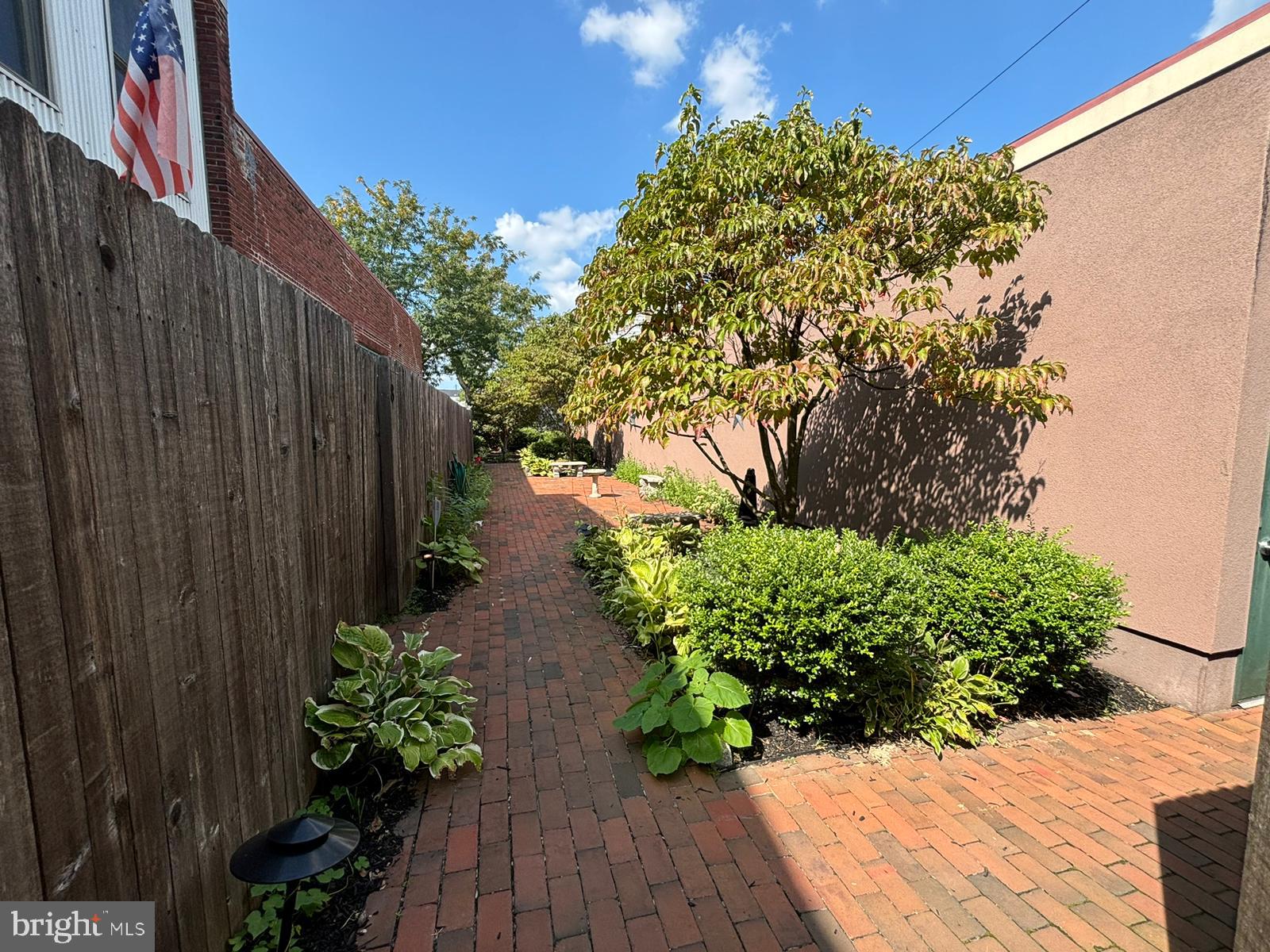 242 Centre Street, Unit 12 Trenton, NJ 08611 - Photo 23 of 23 a backyard with potted plants and wooden fence