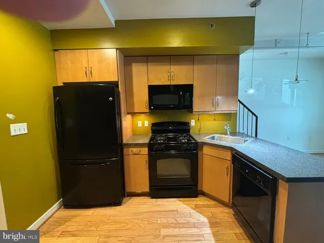 a kitchen with a refrigerator and a stove