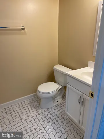 a white toilet sitting next to a shower