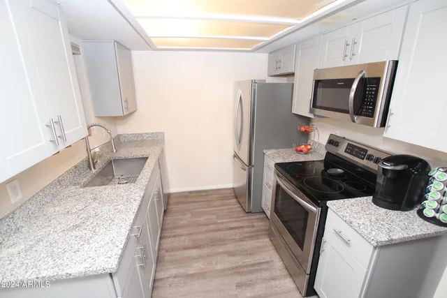 a kitchen with a sink stove and refrigerator