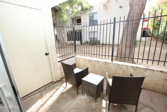 a view of swimming pool with outdoor seating and plants