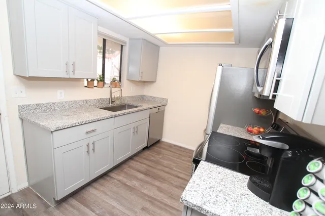 a kitchen with a sink stove and cabinets