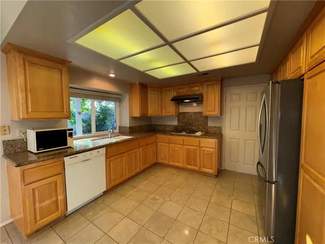 a kitchen with a sink cabinets and window