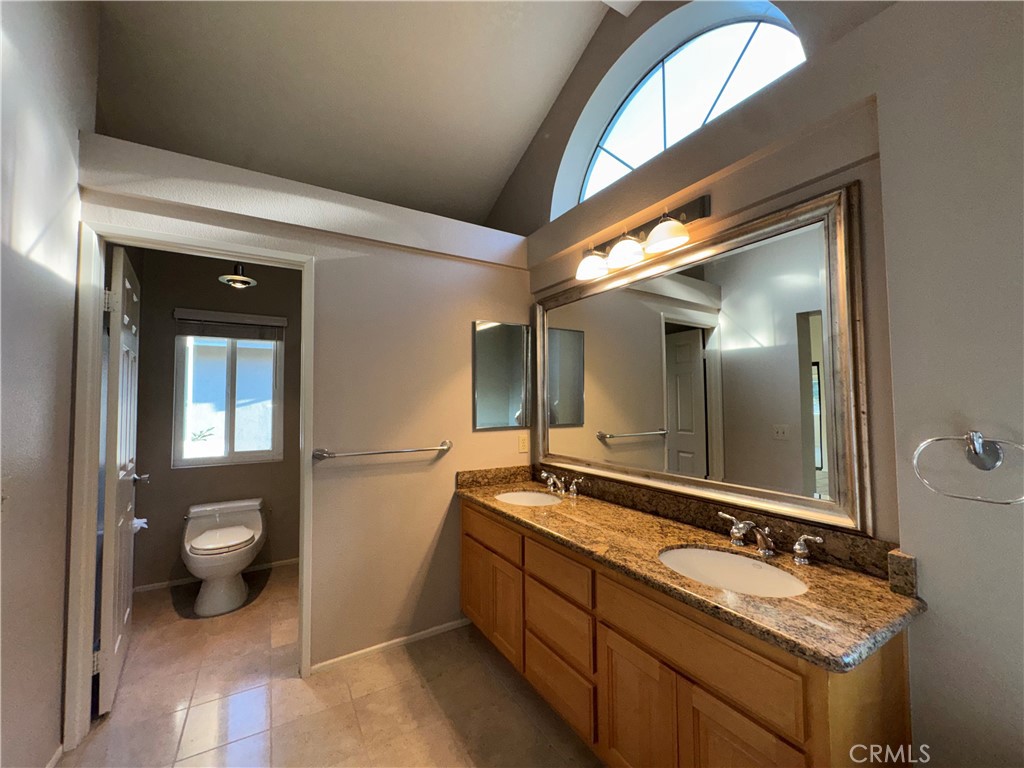 6 Fierro Irvine, CA 92614 - Photo 23 of 29 a spacious bathroom with a granite countertop sink and a mirror
