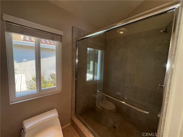 a bathroom with a granite countertop sink mirror vanity and toilet