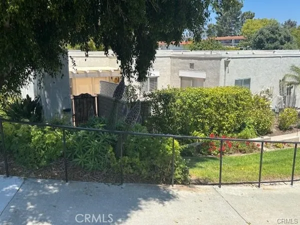 a view of a house with a fence in forest