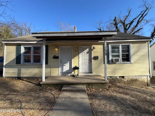 a view of a house with a wooden deck