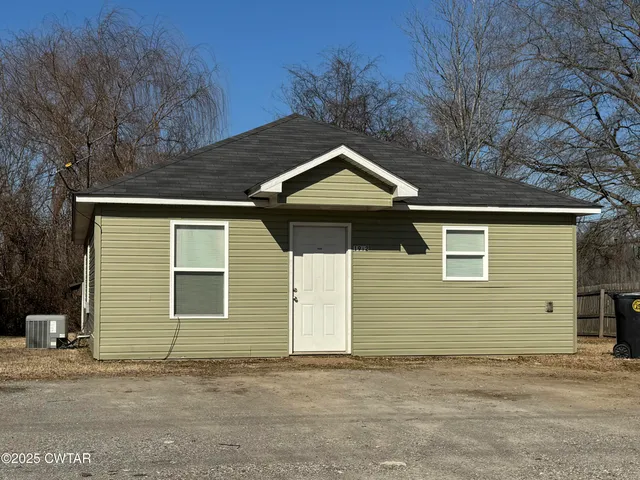 a side view of a house with a garage