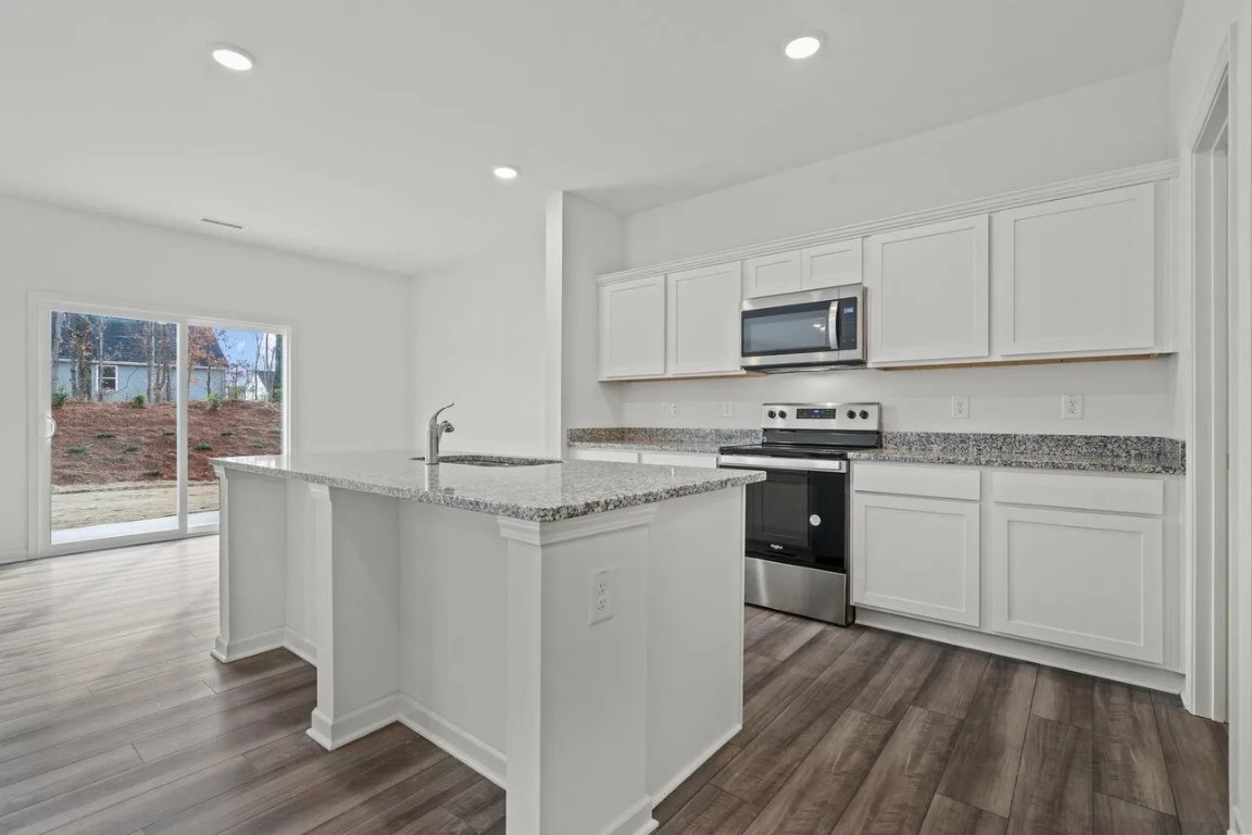 2458 Spring Rise Lane Crosby, TX 77532 - Photo 6 of 17 a kitchen with granite countertop white cabinets and white appliances