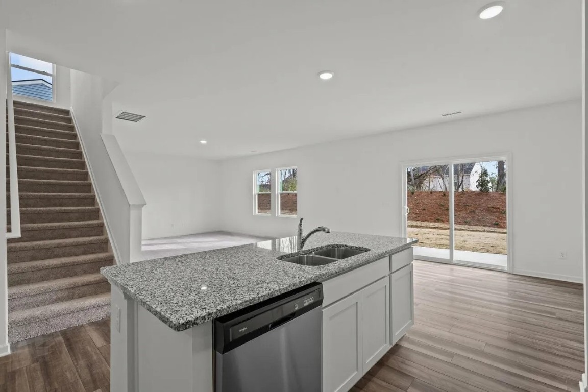 2458 Spring Rise Lane Crosby, TX 77532 - Photo 7 of 17 a kitchen with granite countertop a sink and wooden floor