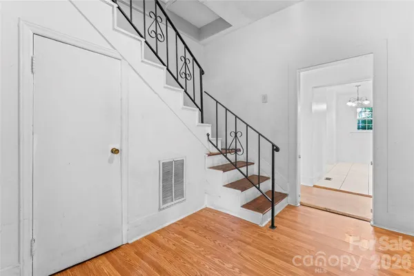 a view of entryway and hall with wooden floor