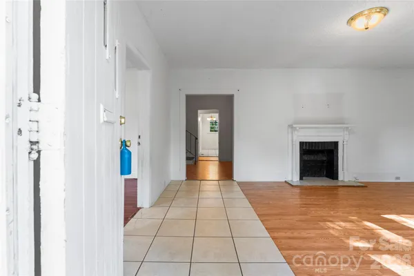 a view of a hallway with an entryway and fire place