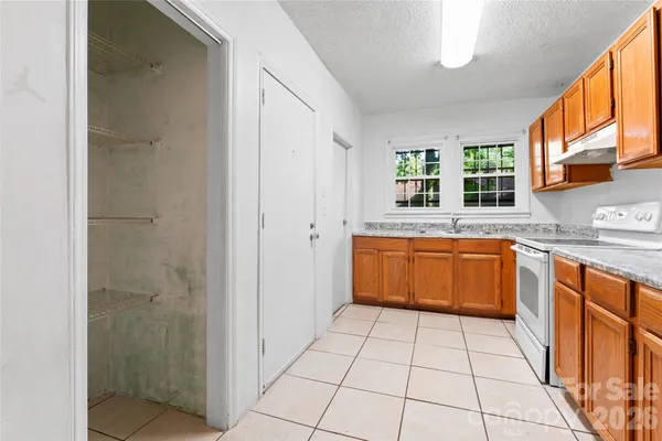a kitchen with stainless steel appliances granite countertop a sink and cabinets