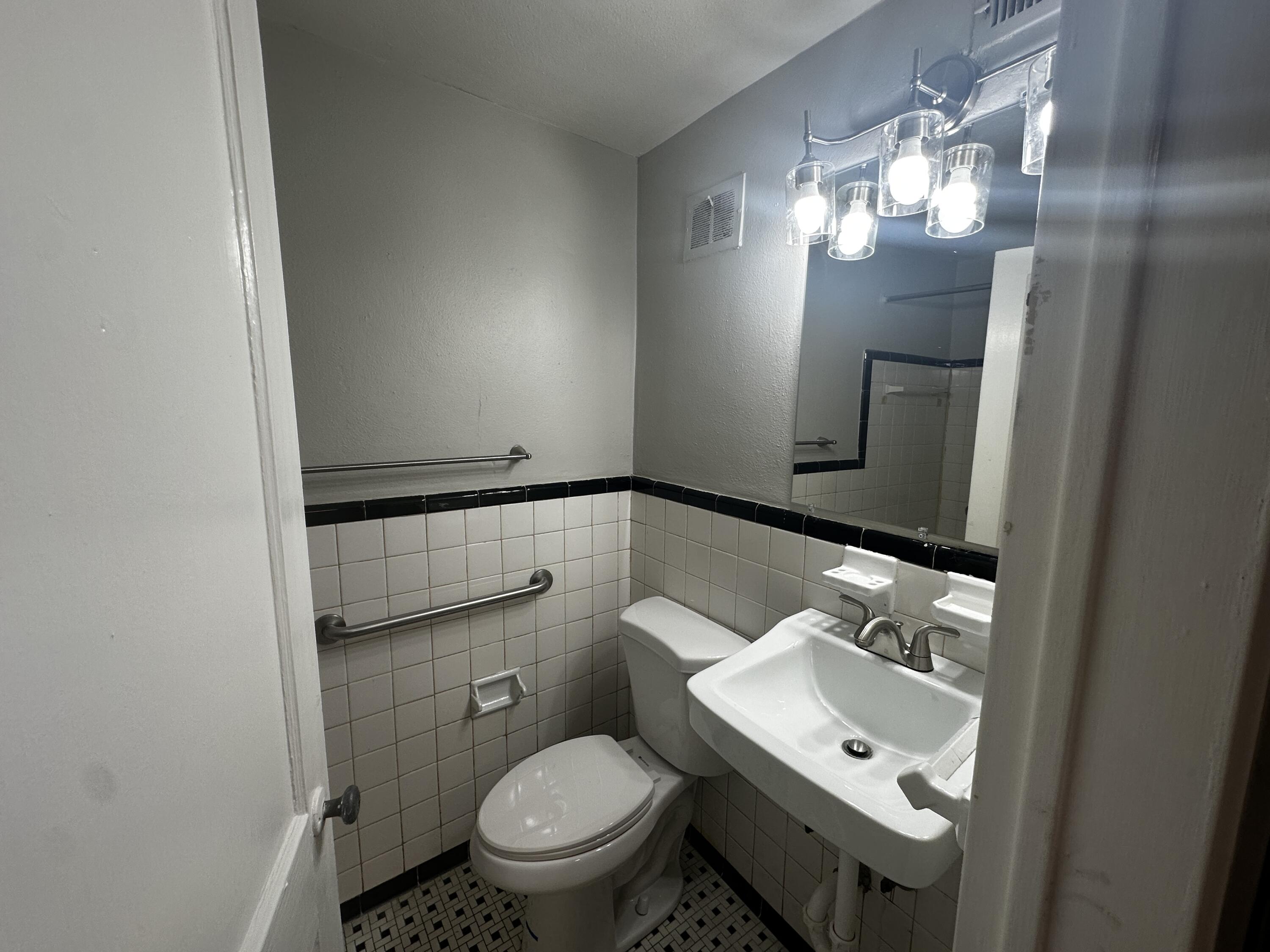 1722 Grandin Road Southwest, Unit 31 Roanoke, VA 24015 - Photo 2 of 8 a bathroom with a toilet sink and mirror
