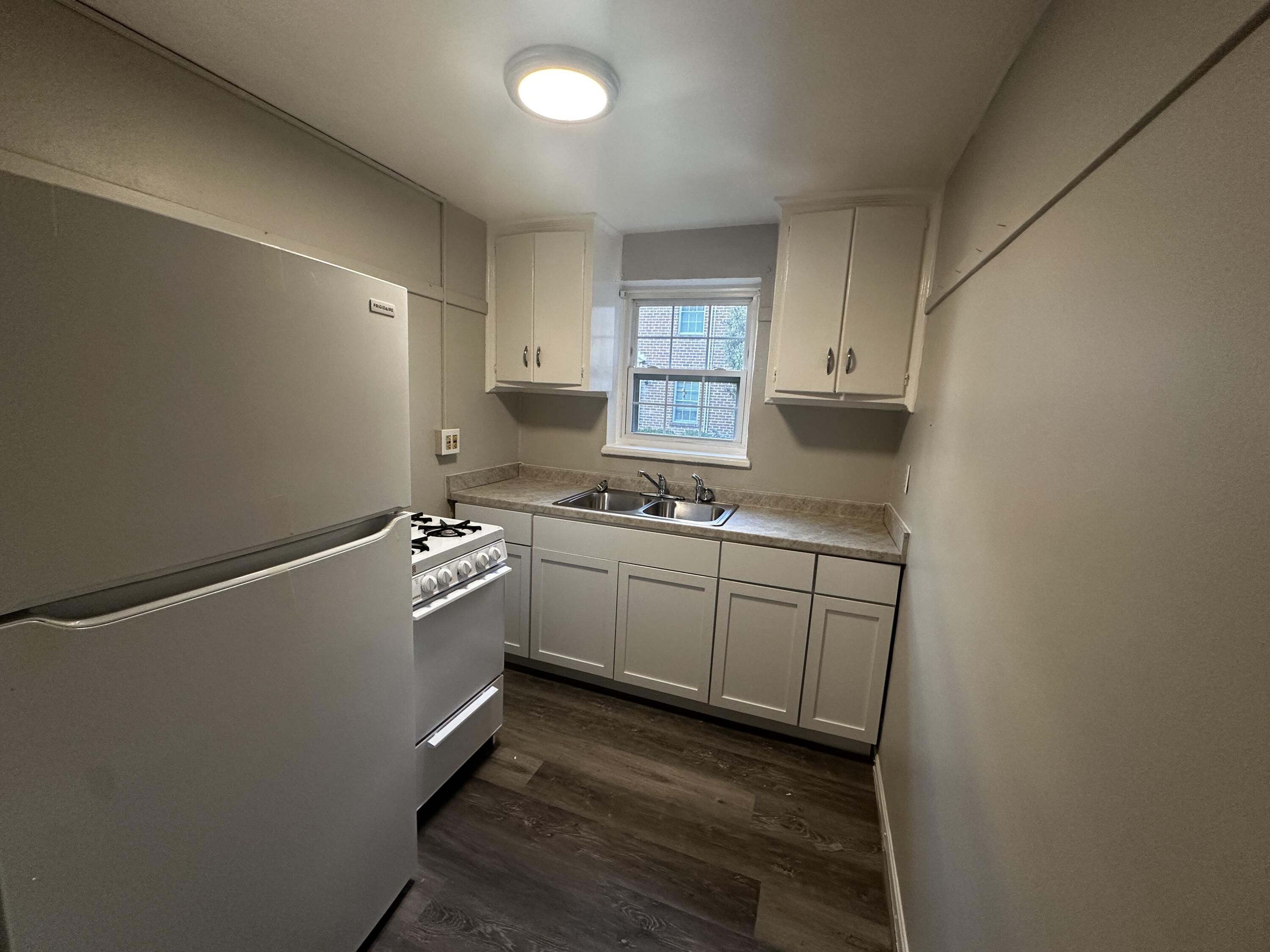1722 Grandin Road Southwest, Unit 31 Roanoke, VA 24015 - Photo 8 of 8 a kitchen with cabinets appliances and a window
