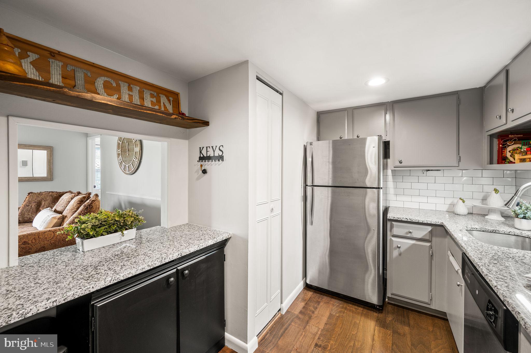 307 Old Forge Crossing Devon, PA 19333 - Photo 11 of 29 a kitchen with stainless steel appliances granite countertop a refrigerator and a sink