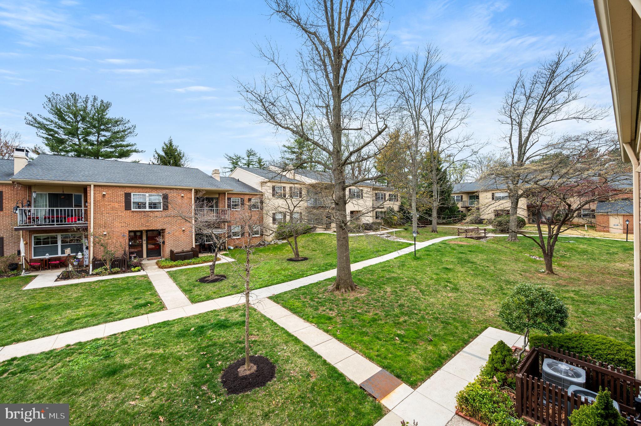 307 Old Forge Crossing Devon, PA 19333 - Photo 23 of 29 a front view of a house with a yard table and chairs