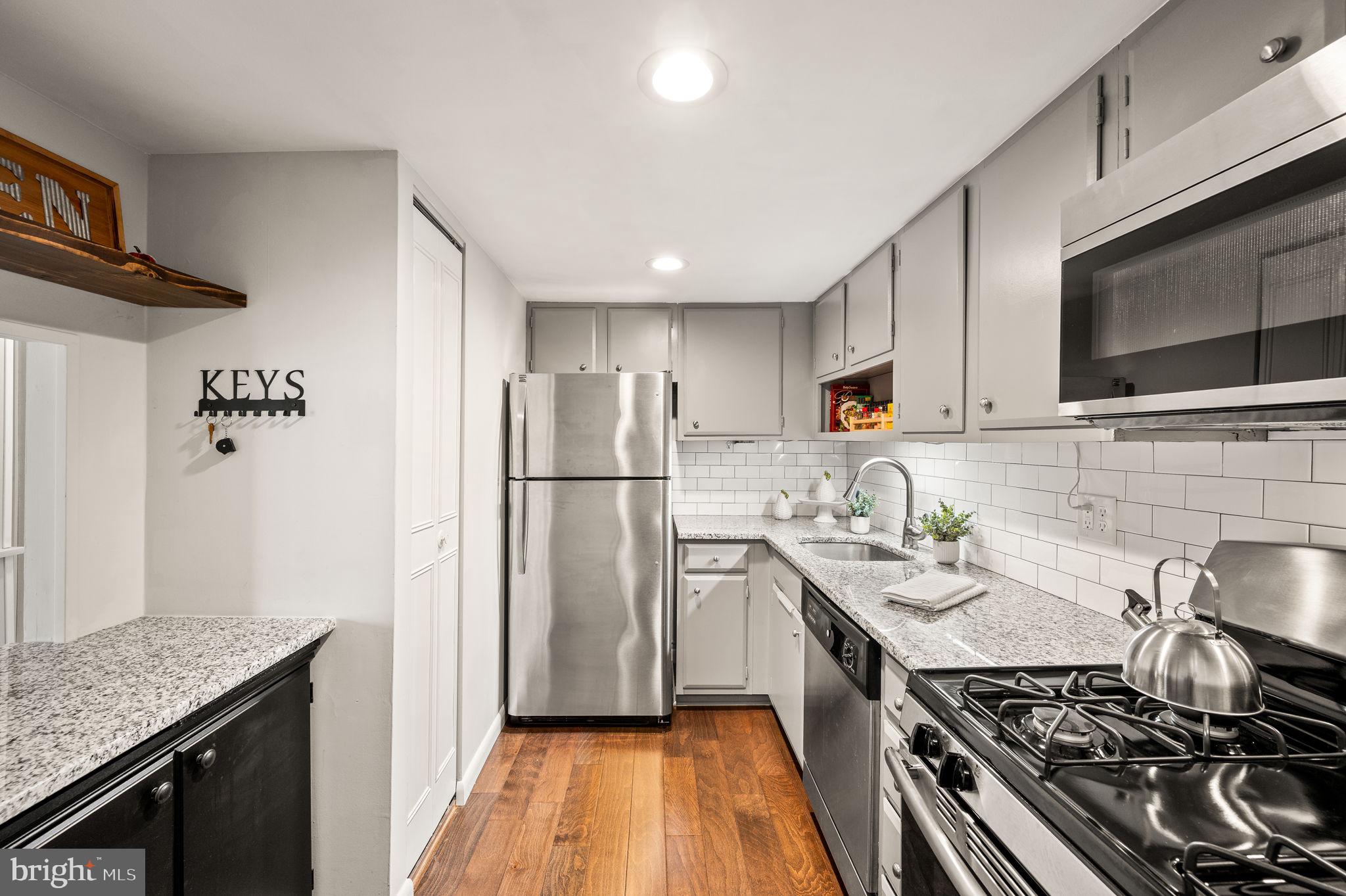 307 Old Forge Crossing Devon, PA 19333 - Photo 10 of 29 a kitchen with stainless steel appliances granite countertop a stove a refrigerator and a sink