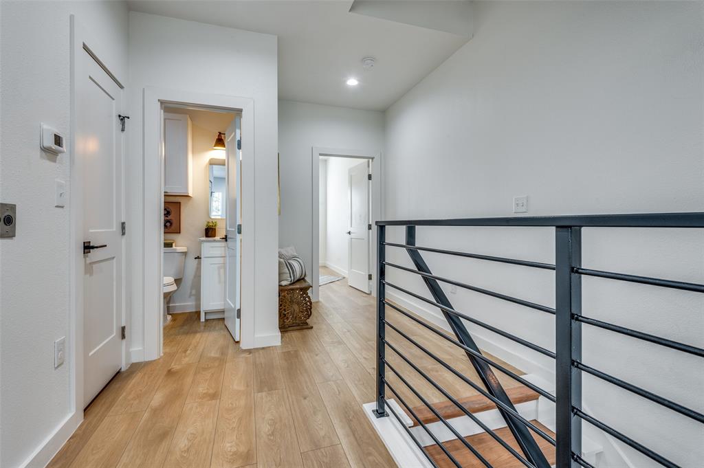 504 South O Connor Road Irving, TX 75060 - Photo 11 of 32 a view of a hallway with wooden floor and staircase