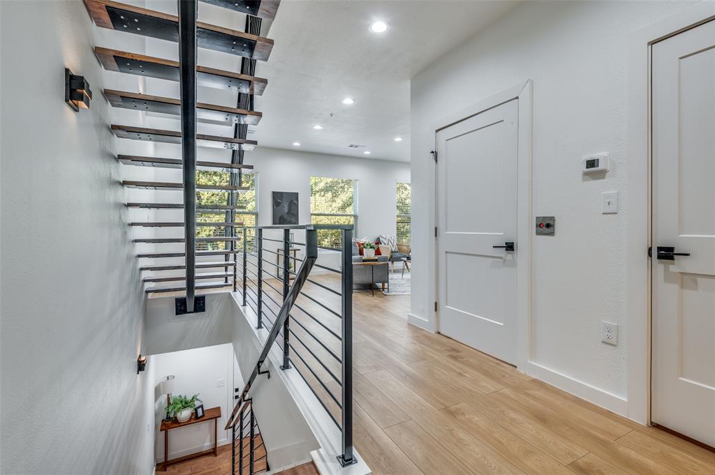 504 South O Connor Road Irving, TX 75060 - Photo 12 of 32 a hallway with wooden floor and windows