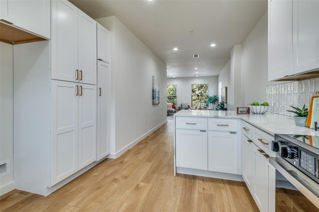 504 South O Connor Road Irving, TX 75060 - Photo 19 of 32 a kitchen with white cabinets and appliances