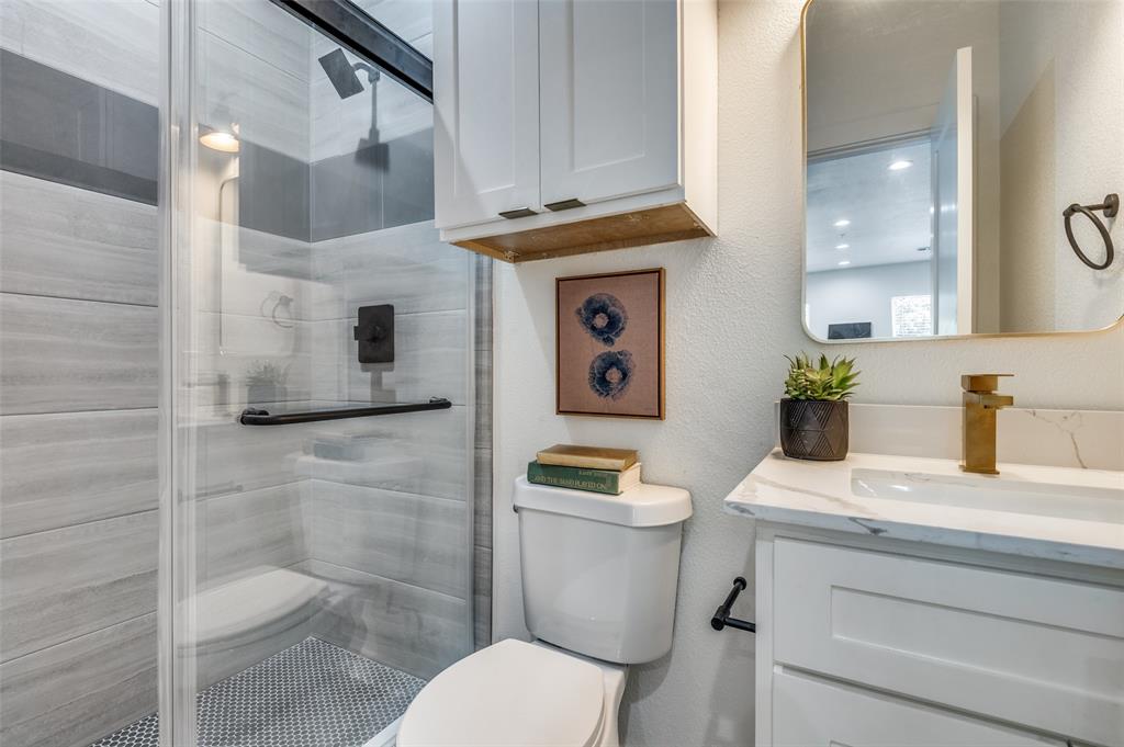 504 South O Connor Road Irving, TX 75060 - Photo 21 of 32 a bathroom with a sink a toilet and mirror