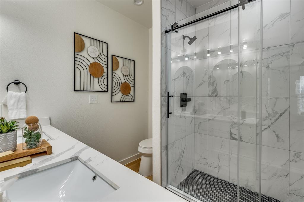 504 South O Connor Road Irving, TX 75060 - Photo 23 of 32 a bathroom with a shower and a toilet